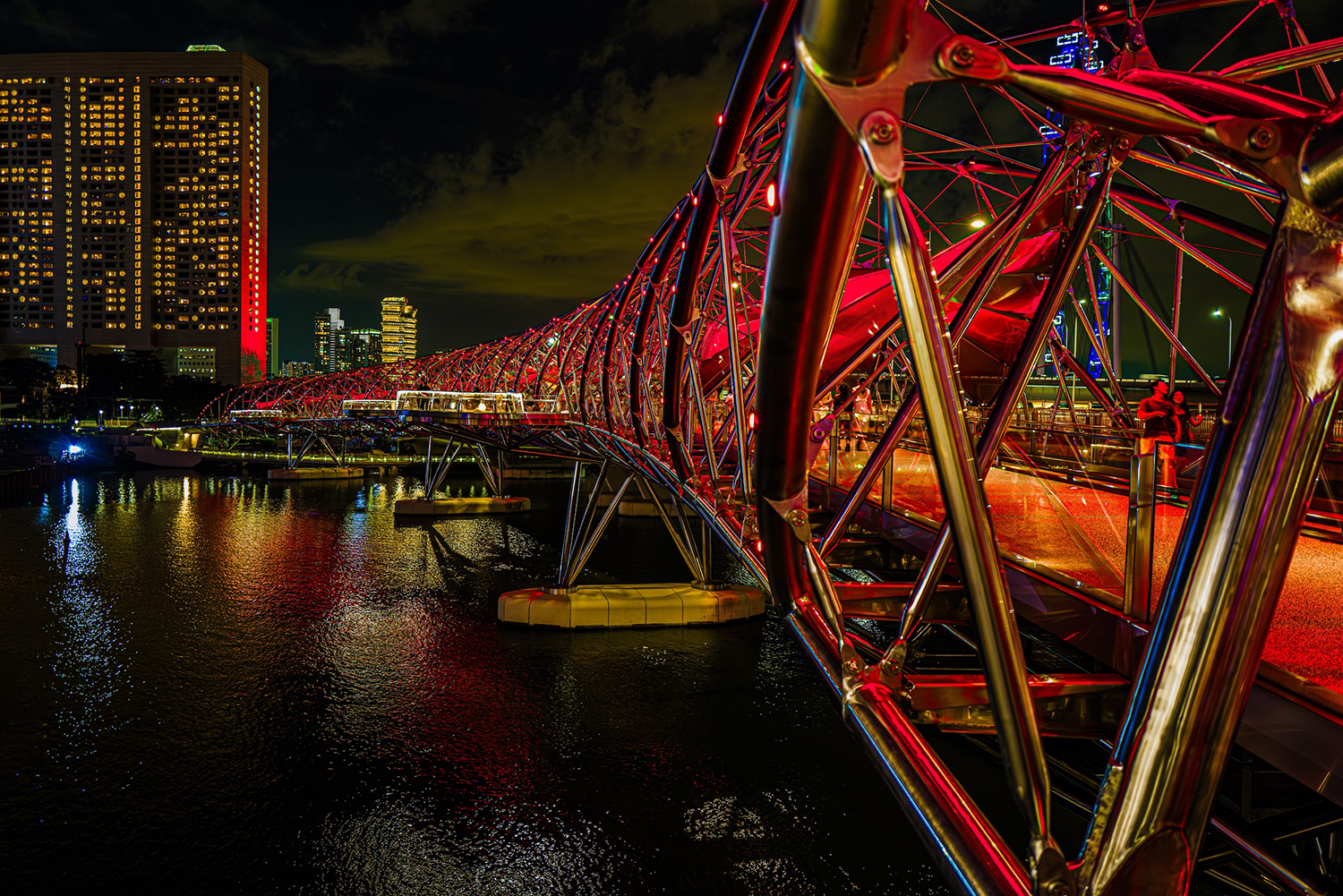 Photo of the Helix pedestrian bridge in Marina Bay, Singapore, at night.