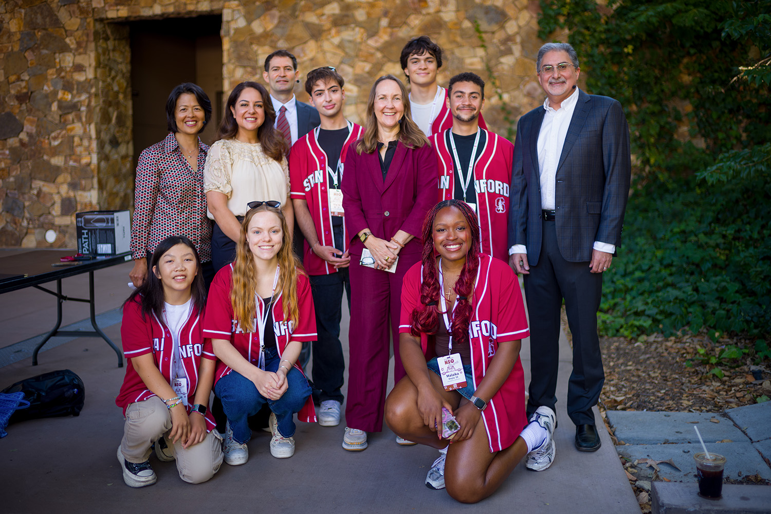 Provost Jenny Martinez poses with panelists and student orientation coordinators on the Frost Amphitheater stage.