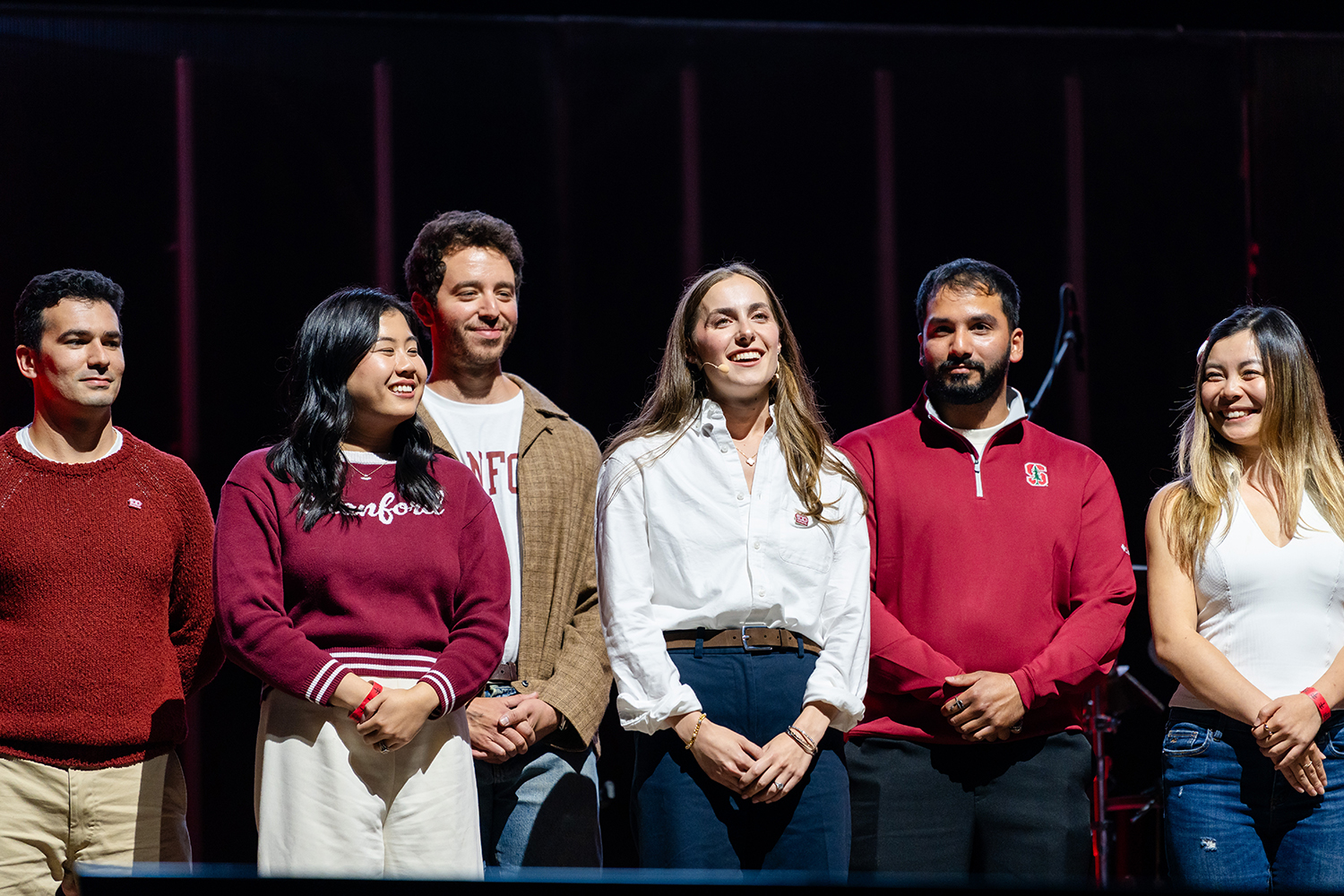 A group of alumni, student, faculty, and staff representatives on the stage. Speaking in the center is 2nd-year MBA student Anne Rosenblatt.