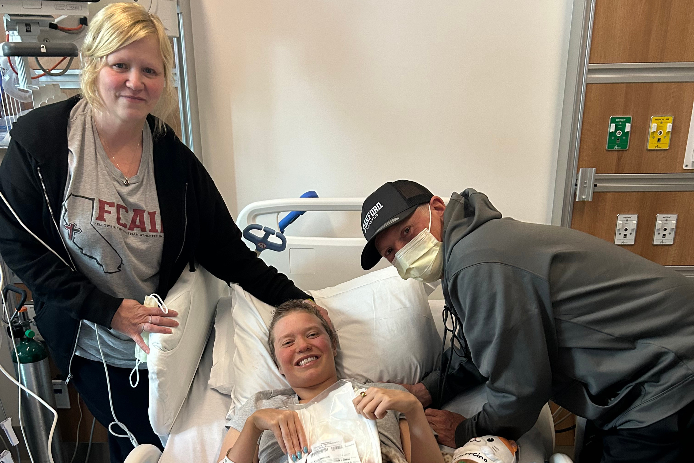 Josie Fabian getting treated for cancer at Stanford Hospital, with her parents beside her