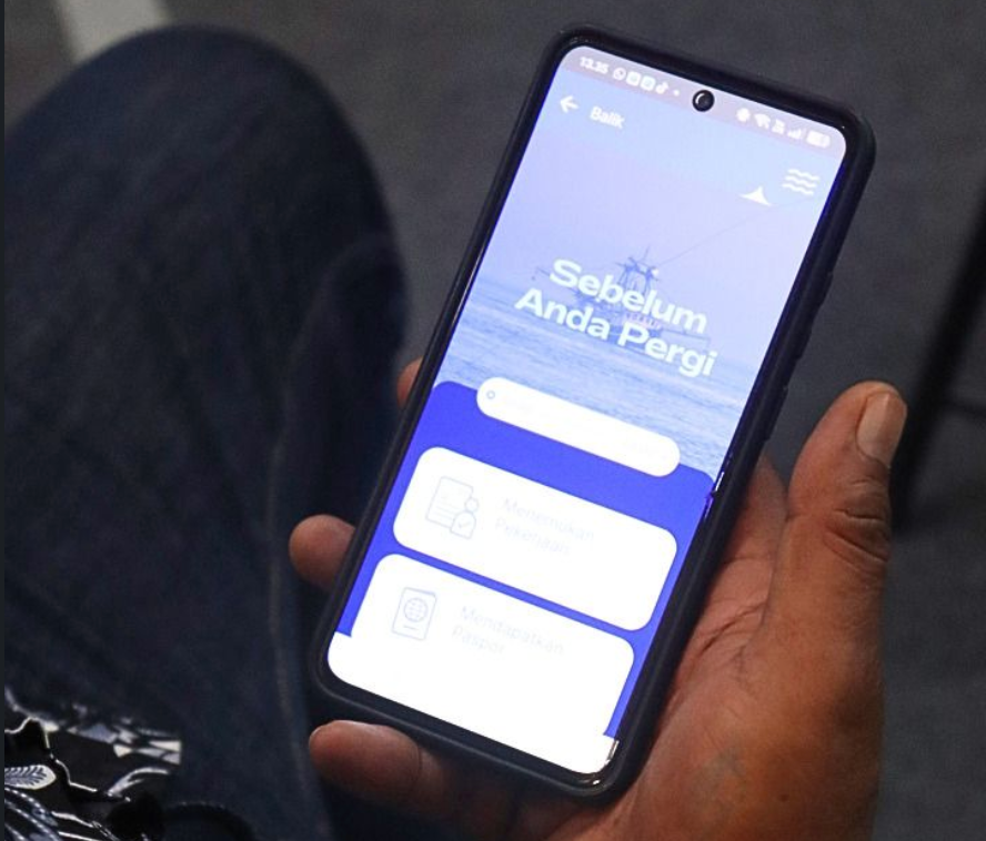 A hand holds a smartphone displaying a travel app with options for planning and checking travel details.