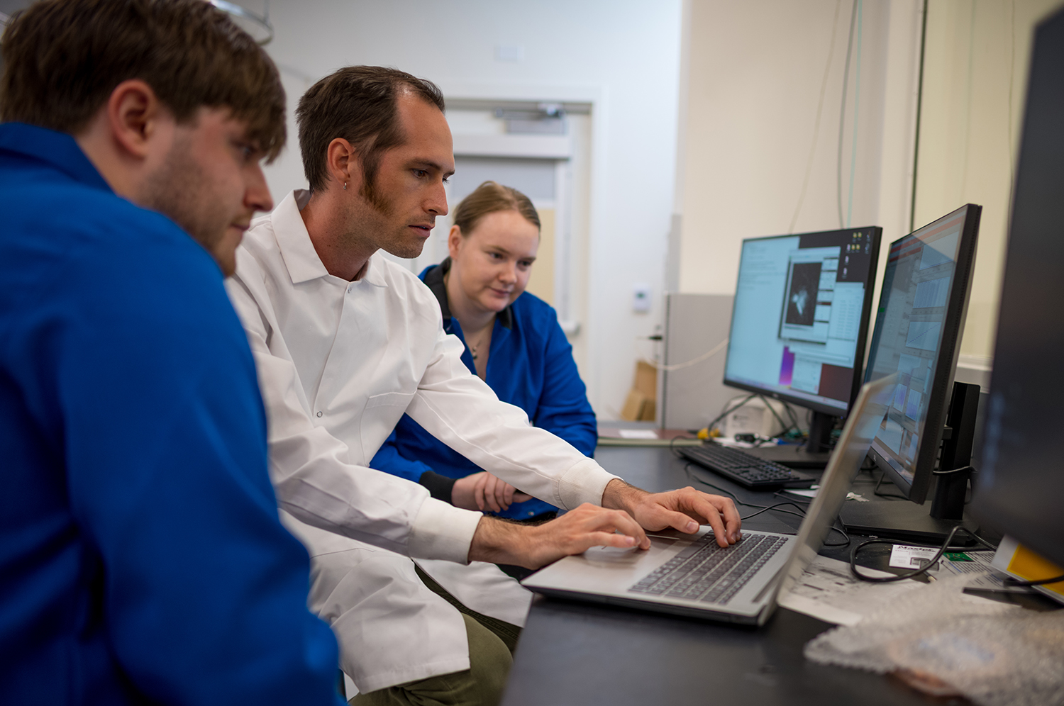 Image of students conducting analysis of XRD data in the X-ray control room.