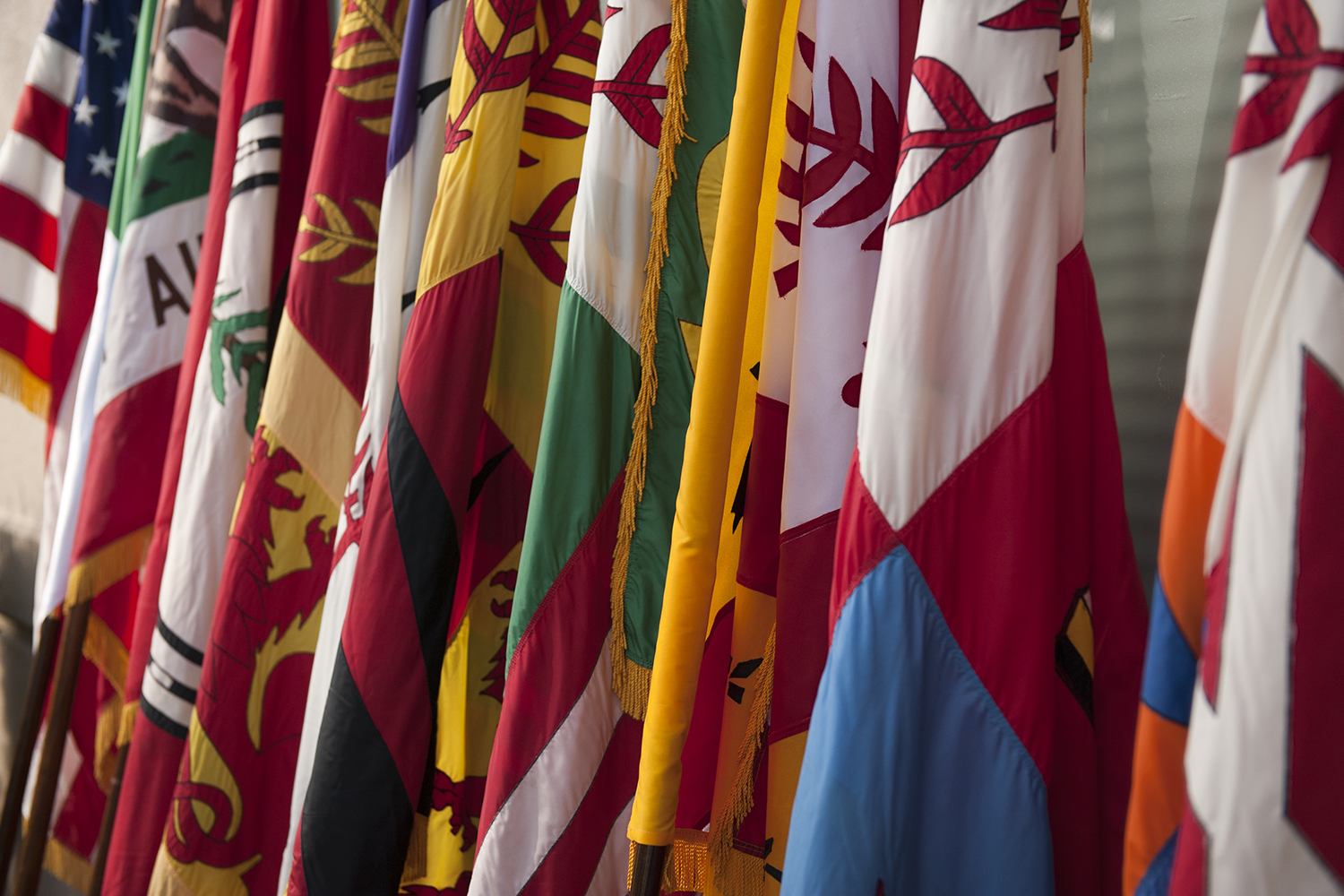 Row of colorful flags from of the schools of the university displayed together.