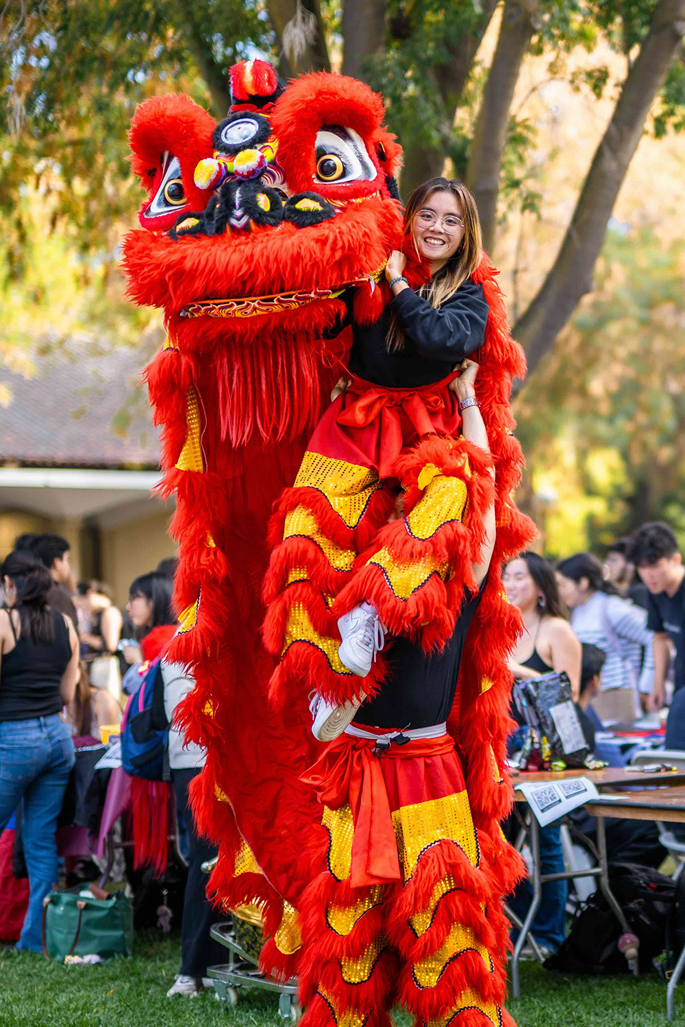 Image of Anh Huynh and Ethan Fung performing to draw attention to the Stanford Lion Dance club.