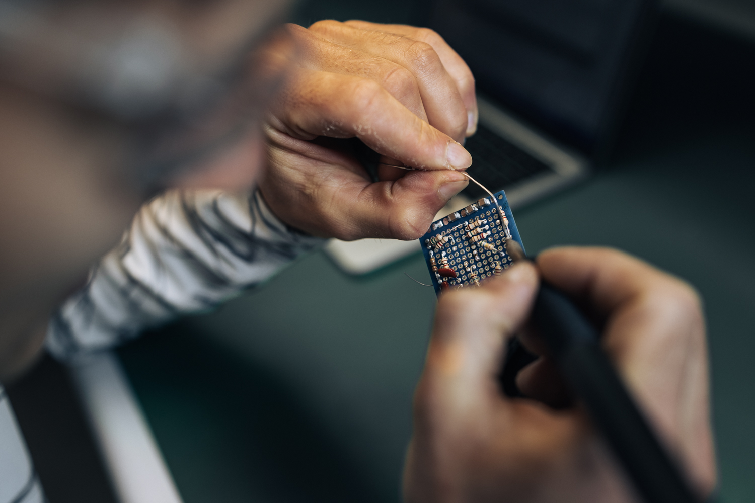 Connor Herson assembles a circuit board in preparation for soldering.