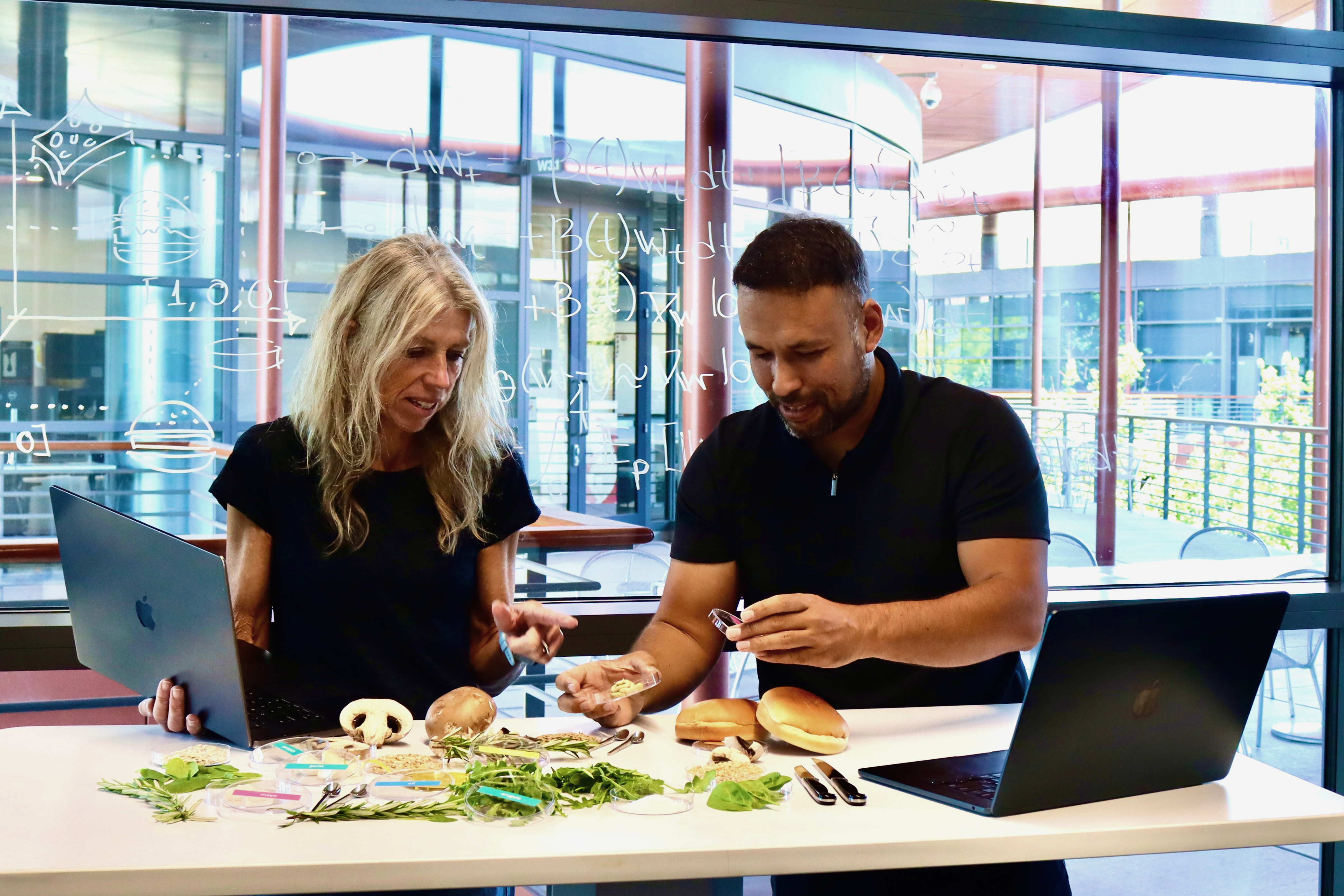 Ellen Kuhl and Vahidullah Tac inspect ingredients for the AI-designed sustainable mushroom burger.