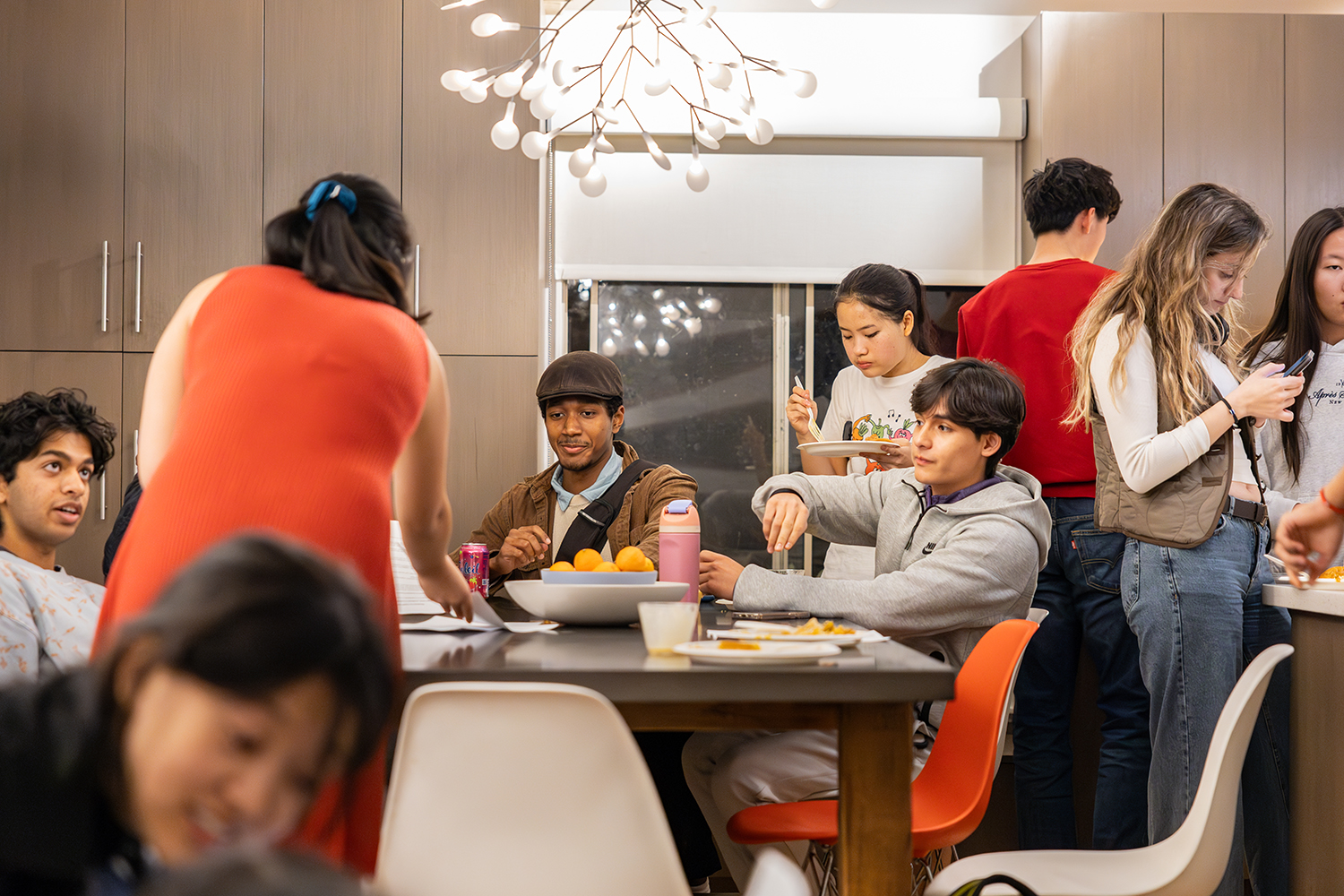 Students gathered around a table and eating snacks during a Civic Salon discussion.