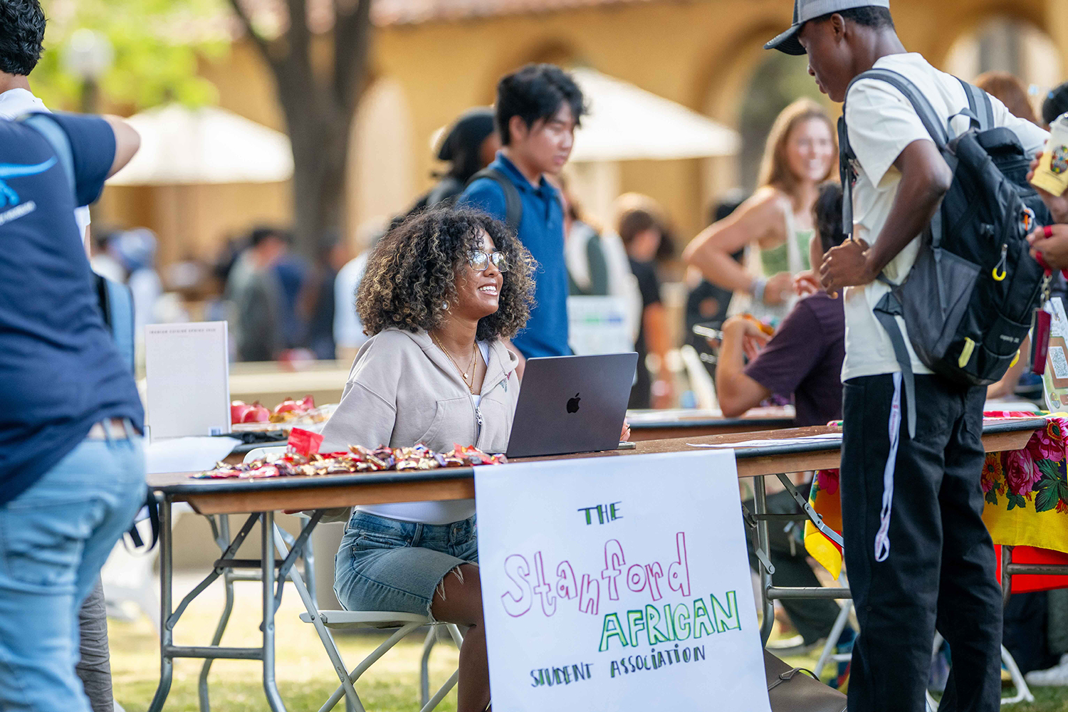 Image of a member of the Stanford African Student Association meeting with Festifall attendees.
