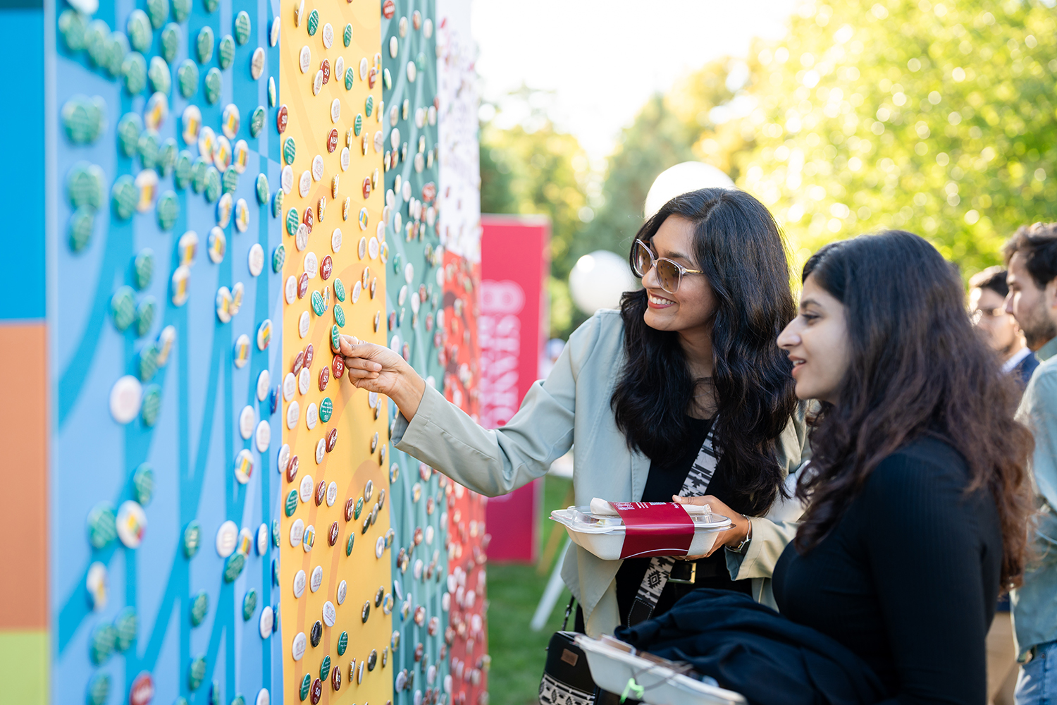 Attendees choose buttons from the wall at Frost Amphitheater