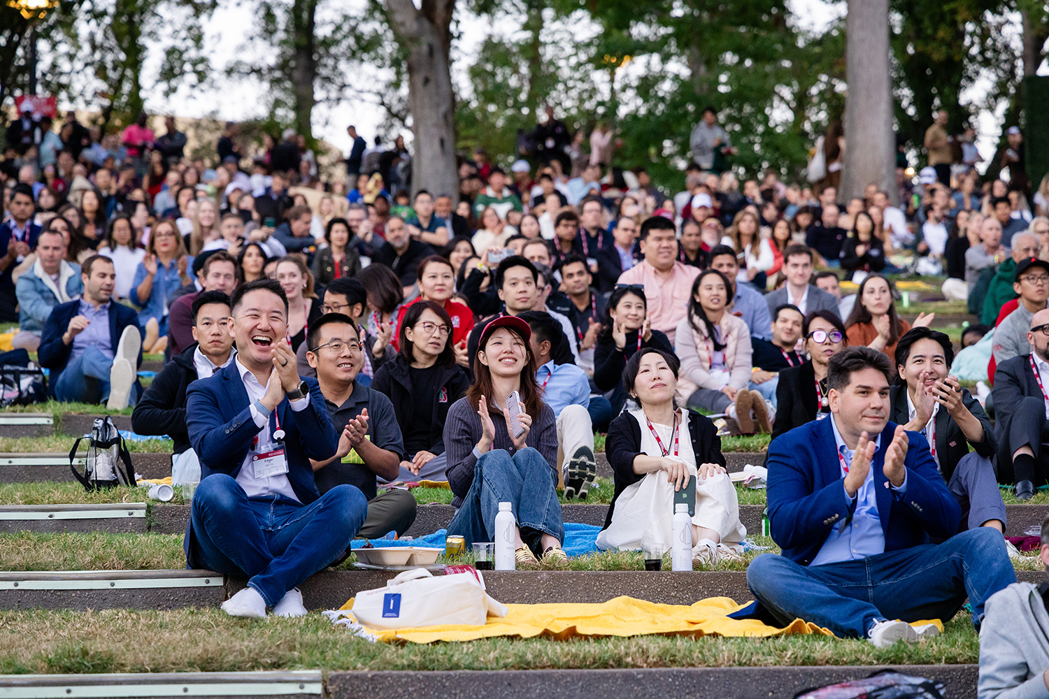 Audience members seated on the grass steps at Frost Amphitheater.