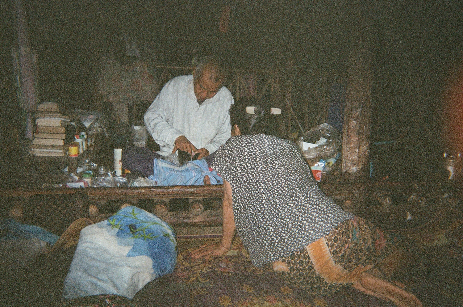 Photo of two people in their home located in the Mae La Refugee Camp in Thailand.