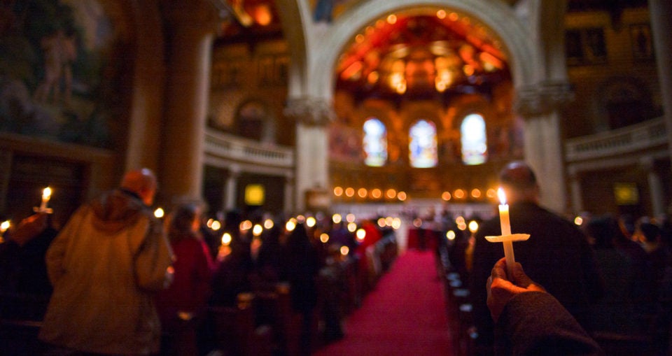 candelit Memorial Church in background with candle in shape of cross at community gathering on Inauguration Day