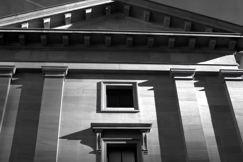 Black and white photo of a bank from below, in deep shadow and looking foreboding.