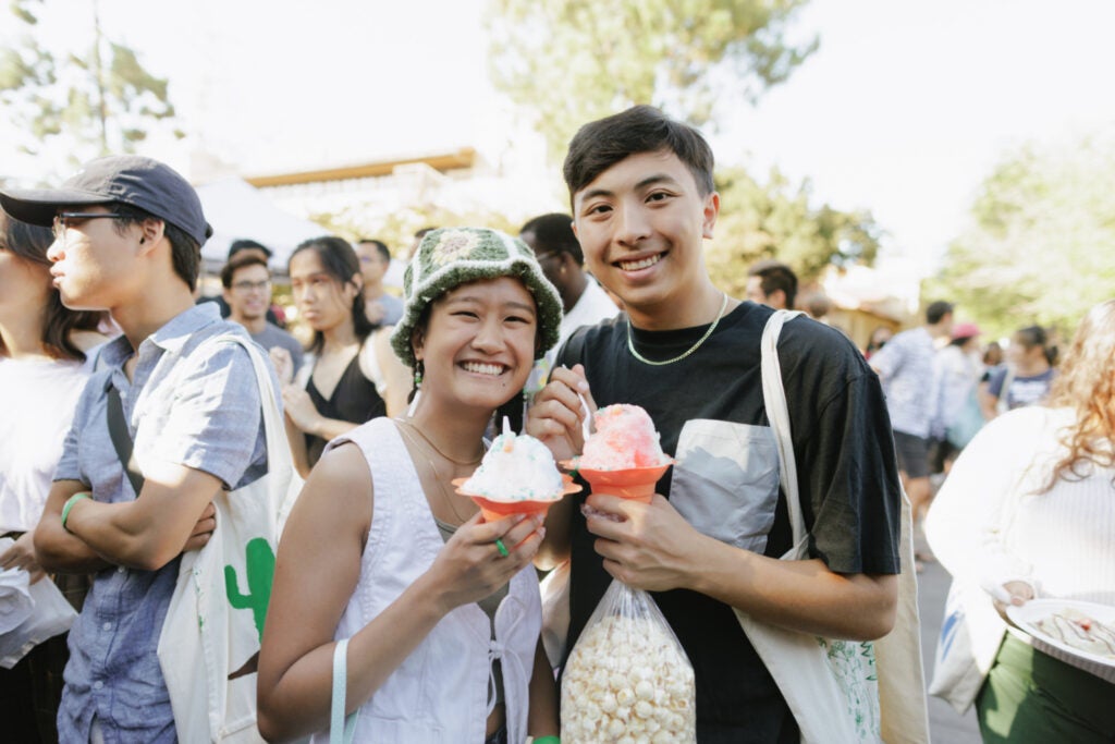 Two students holding eating shave ice