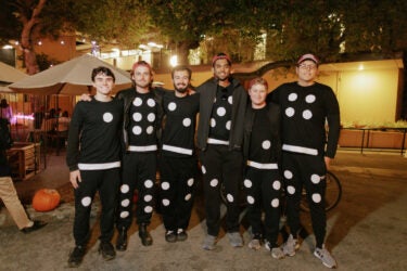 Group photo of students in matching domino costumes at Tresidder
