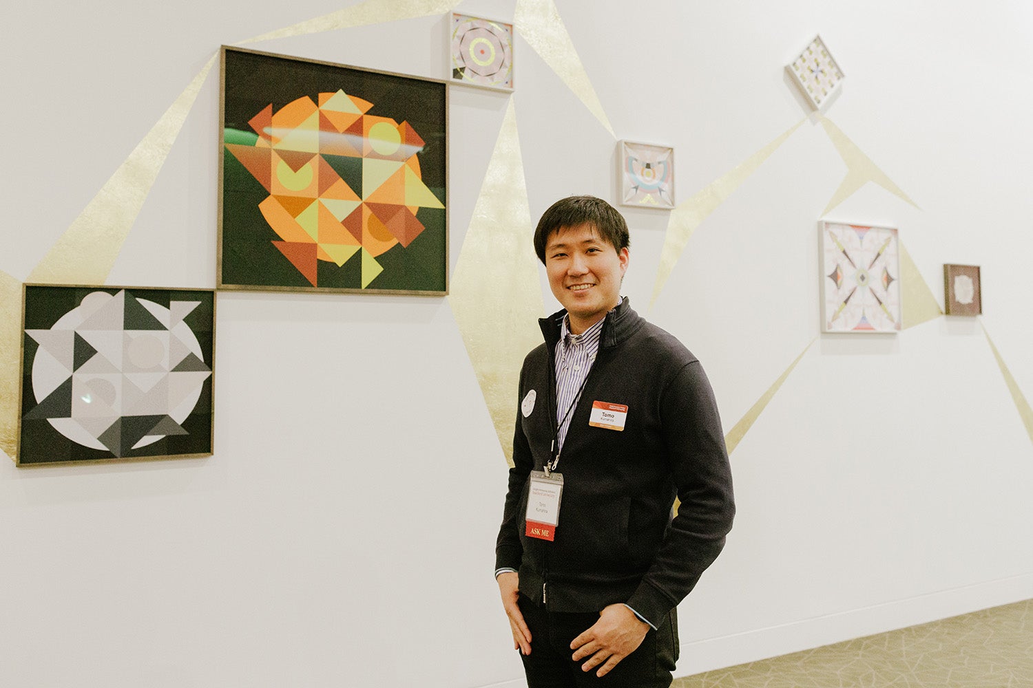 Tomo Kumahira, a Knight-Hennessy Scholar and MBA candidate at the Graduate School of Business, in front of Pregnant Mountains by artist Haegue Yang of South Korea.