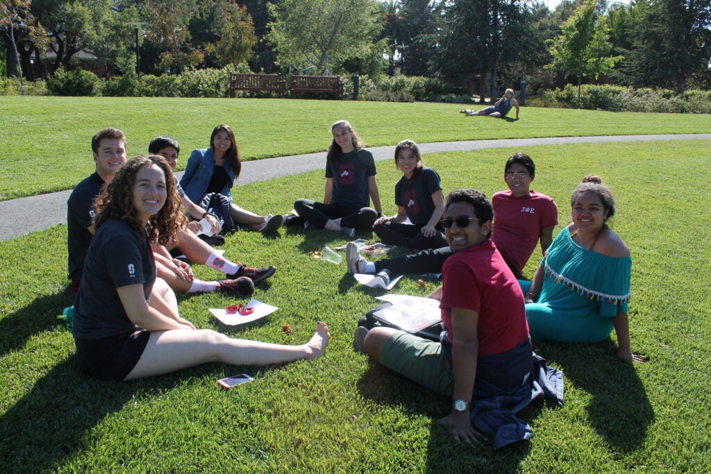 Frosh 101 student participants gather on campus green