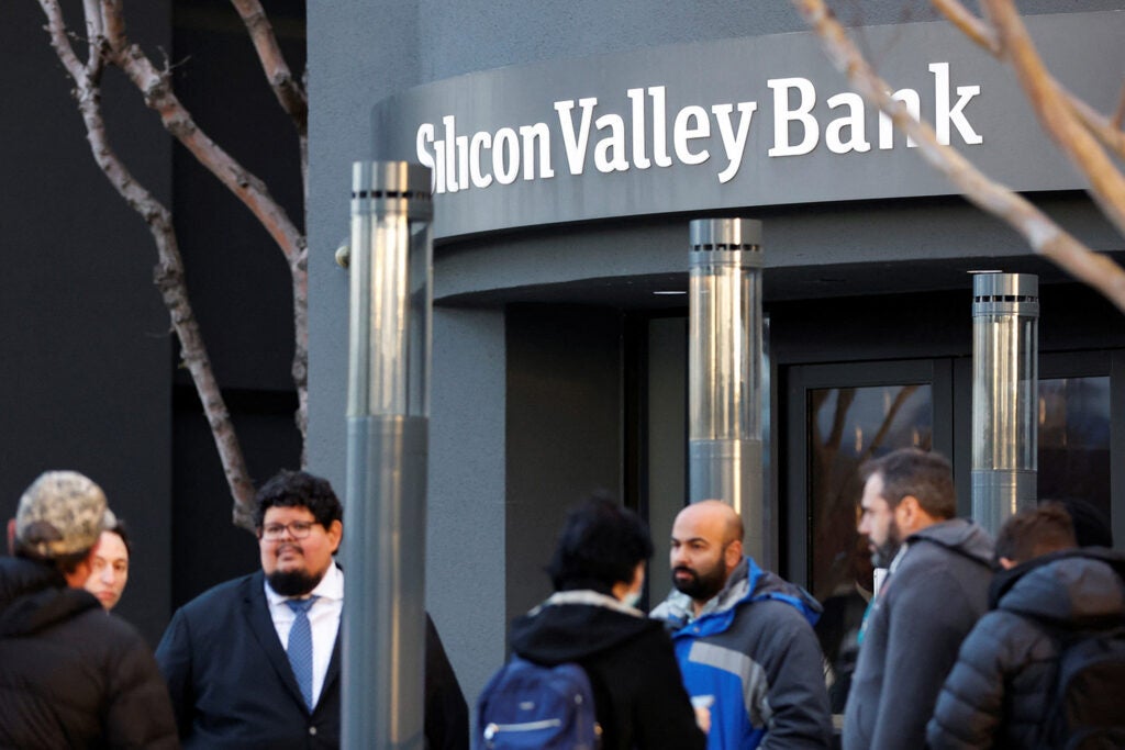 FDIC representatives speak with customers outside of the Silicon Valley Bank headquarters in Santa Clara.