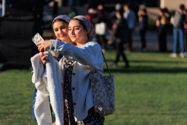 Two students taking a selfie at sunset.