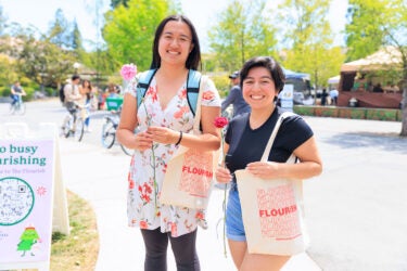 Two students with tote bags.