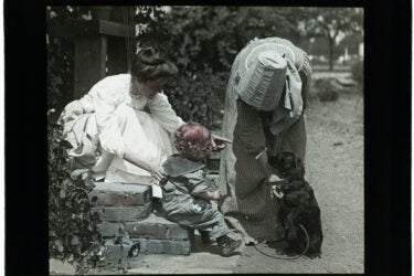 Harry Peterson, the first curator of the Leland Stanford Jr. Museum (now the Cantor Arts Center), was also a photographer. This image from his Home Series features his wife and son enchanted by a charming black dog.