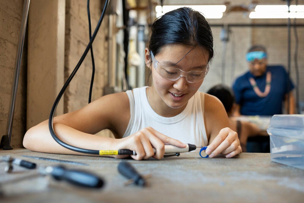 Undergraduate student Vanessa Chen works on a jewelry project during the Arts Intensive program.