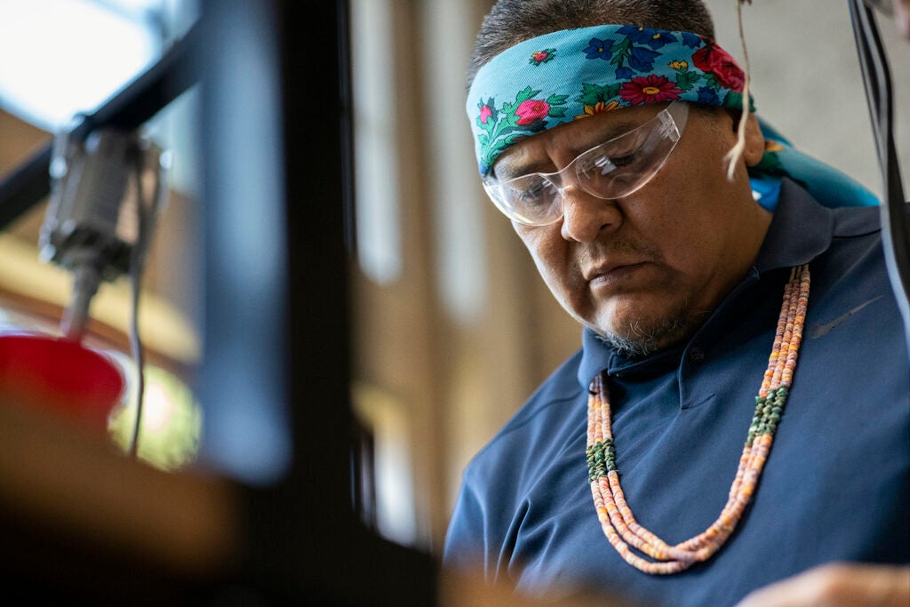Closeup of artist Robert Blackhat Jr., one of two visiting Navajo artists who spent two and a half days with undergraduate students in the Arts Intensive course in September 2023.