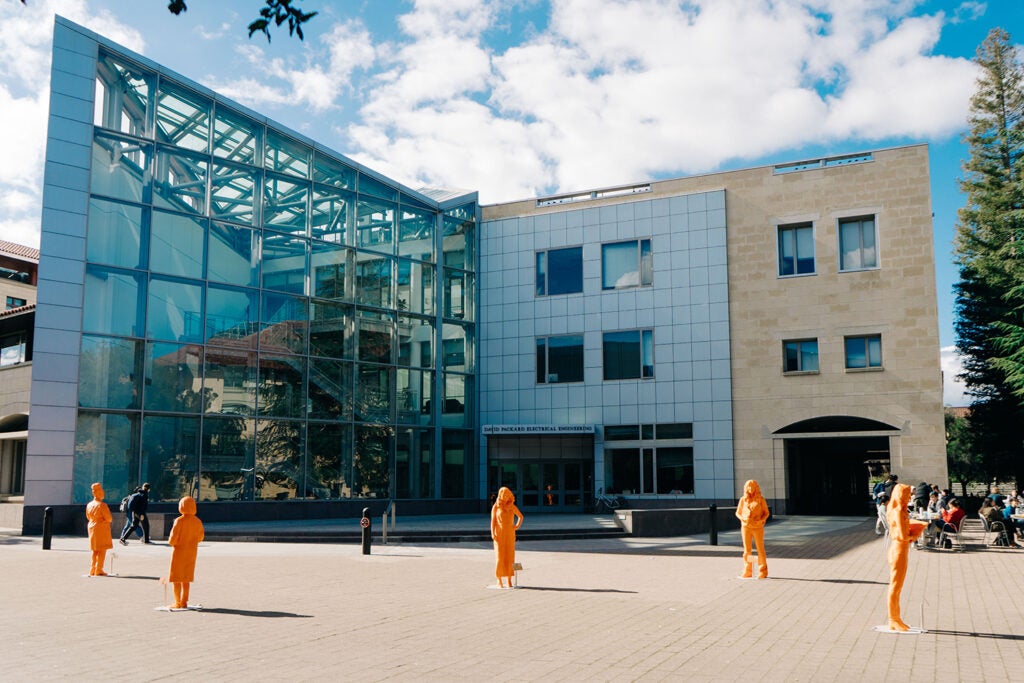 Five life-size, bright orange statues of contemporary STEM women innovators and role models affiliated with Stanford on display between the Hewlett Teaching Center and the Packard Electrical Engineering Building as a satellite installation of IfThenSheCan – The Exhibit.