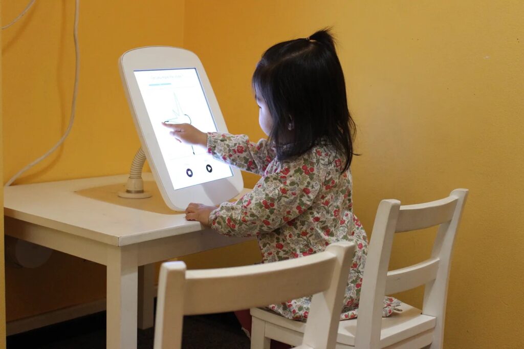A child using a kiosk at the Children’s Discovery Museum of San Jose. Drawings from the kiosk were collected and analyzed using AI to help the researchers better understand how children perceive the world, and how they communicate those perceptions through drawing.