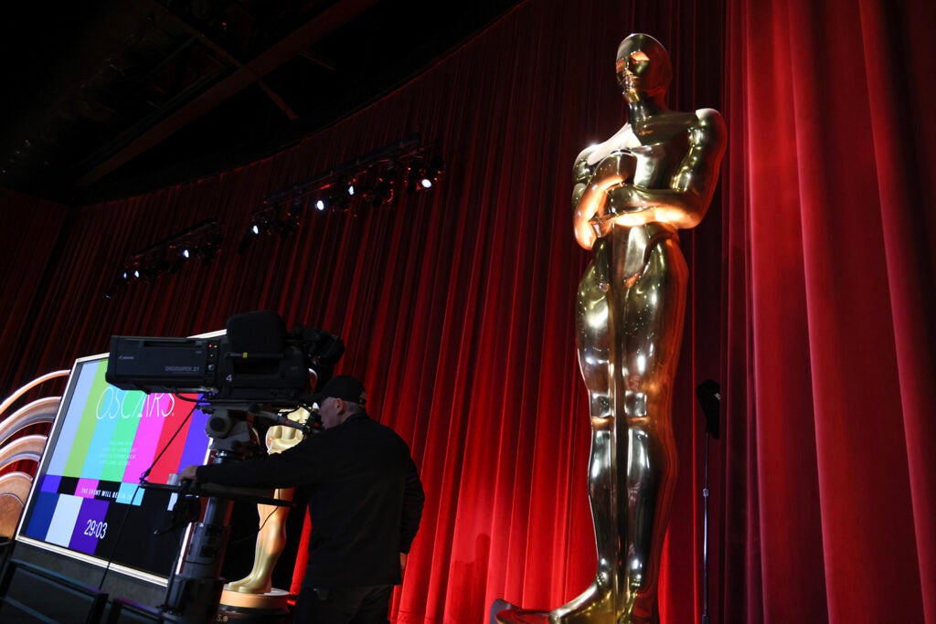 A view of the telecast screen and Oscars statuette