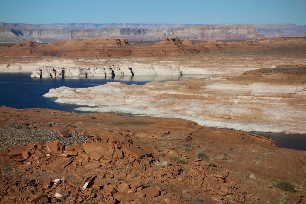 Low water levels reveal the rocky shores of Lake Powell, formed by the damming of the Colorado River in Glen Canyon National Recreation Area, near Page, Arizona.