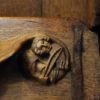 A musician bows a stringed instrument in this wood carving in Winchester Cathedral in the south of England.