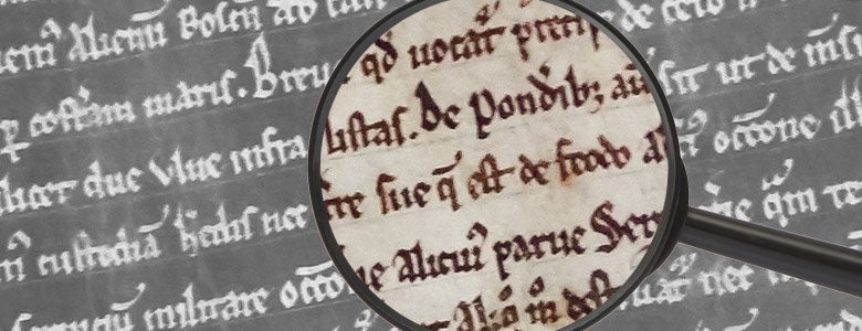 Magnifying glass over text of the Magna Carta