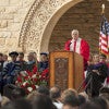 University President John Hennessy at lectern, with faculty on stage, at Stanford's 125th Opening Convocation / L.A. Cicero