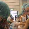 students on an assembly line packaging meals / Kurt Hickman