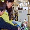 Xiaofei Ye (left) and Liming Zhang adjusting experimental device