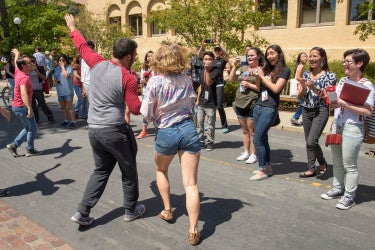 dancers perform at the activities fair for a crowd of admits