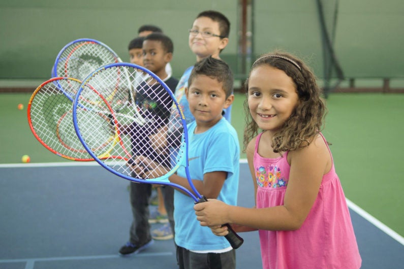 Children learning tennis