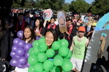 Students wearing balloons crowd near the gate to Stanford Stadium before Wacky Walk