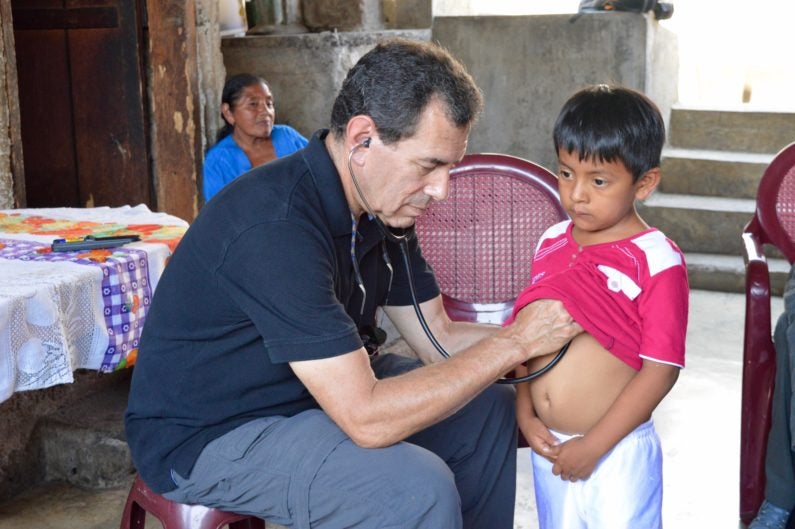 Dr. Paul Wise examining a boy in rural Guatemala