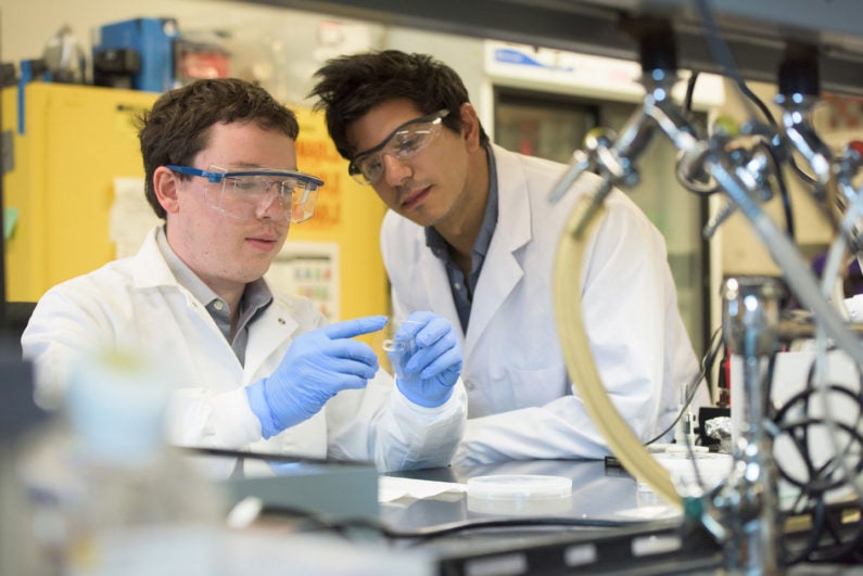 Stanford researchers Greg Pitner and Matt Abramian finalize sample preparation in the Neurofab, mounting the cell culture vessel to the suspended CNT wafer.