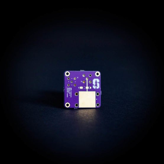 A purple circuit board with a Stanford "S" stamped on it