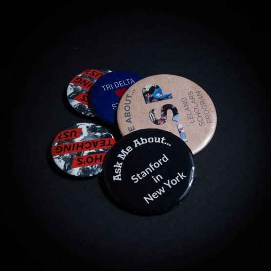 Several buttons with slogans, "Ask me about... Stanford in New York" "Who's teaching us?", "Ask me about Leland Scholars Program", "Tri Delta",