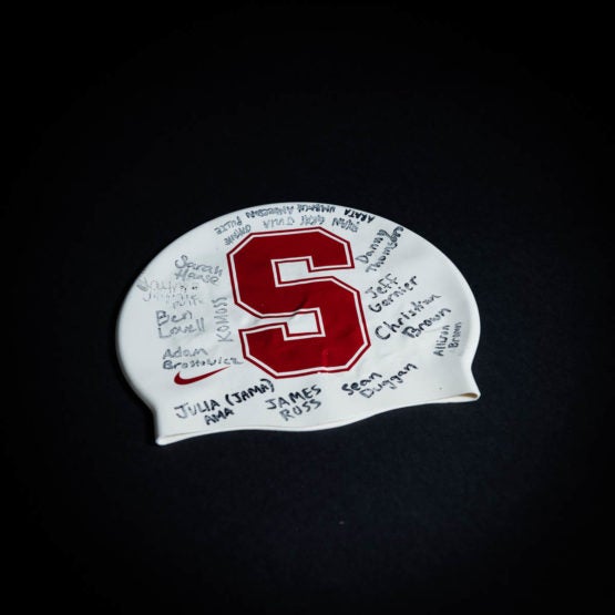 Stanford athletics swim cap featuring the red "S" and student athlete signatures