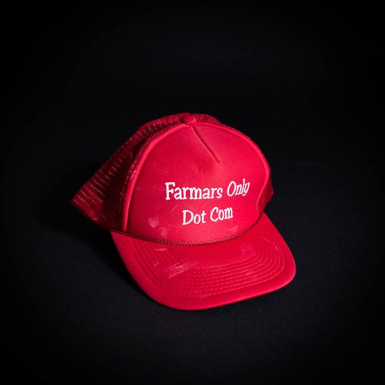 Red hat with "Farmars Only Dot Com" printed on it