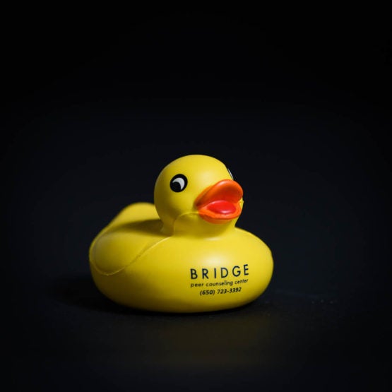 Yellow rubber duckie with contact information for "BRIDGE peer counseling center"