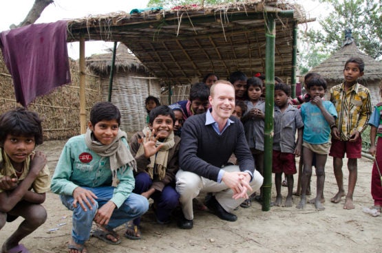 Grant Miller surrounded by children in India.