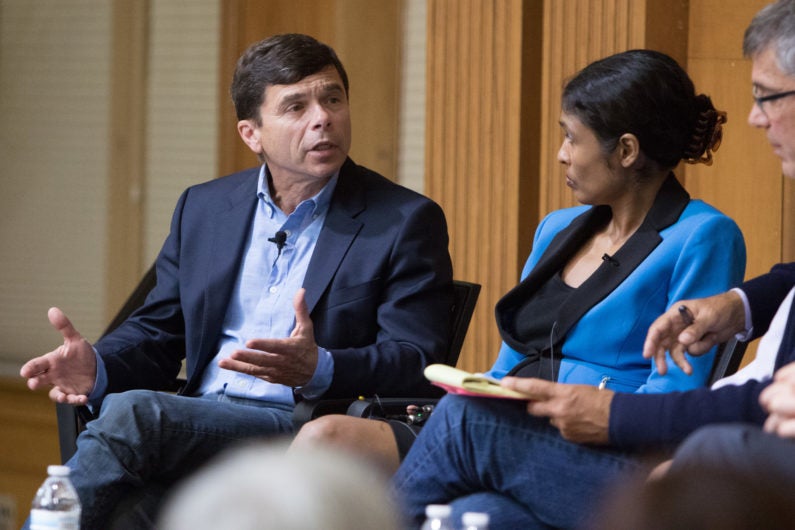 Panelists Michael Rezendes of the Boston Globe and Mary Rajkumar of the Associated Press in discussion on stage at reunion of journalism fellows