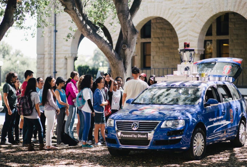 Students gathering at demonstration of an autonomous car