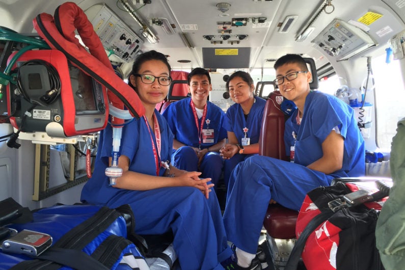 High school students sit in the Stanford Health Care Lifeflight helicopter